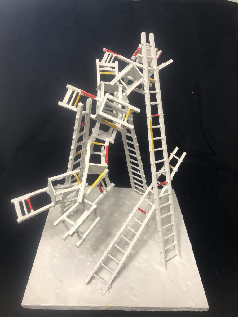 A painted tower of ladders and chairs