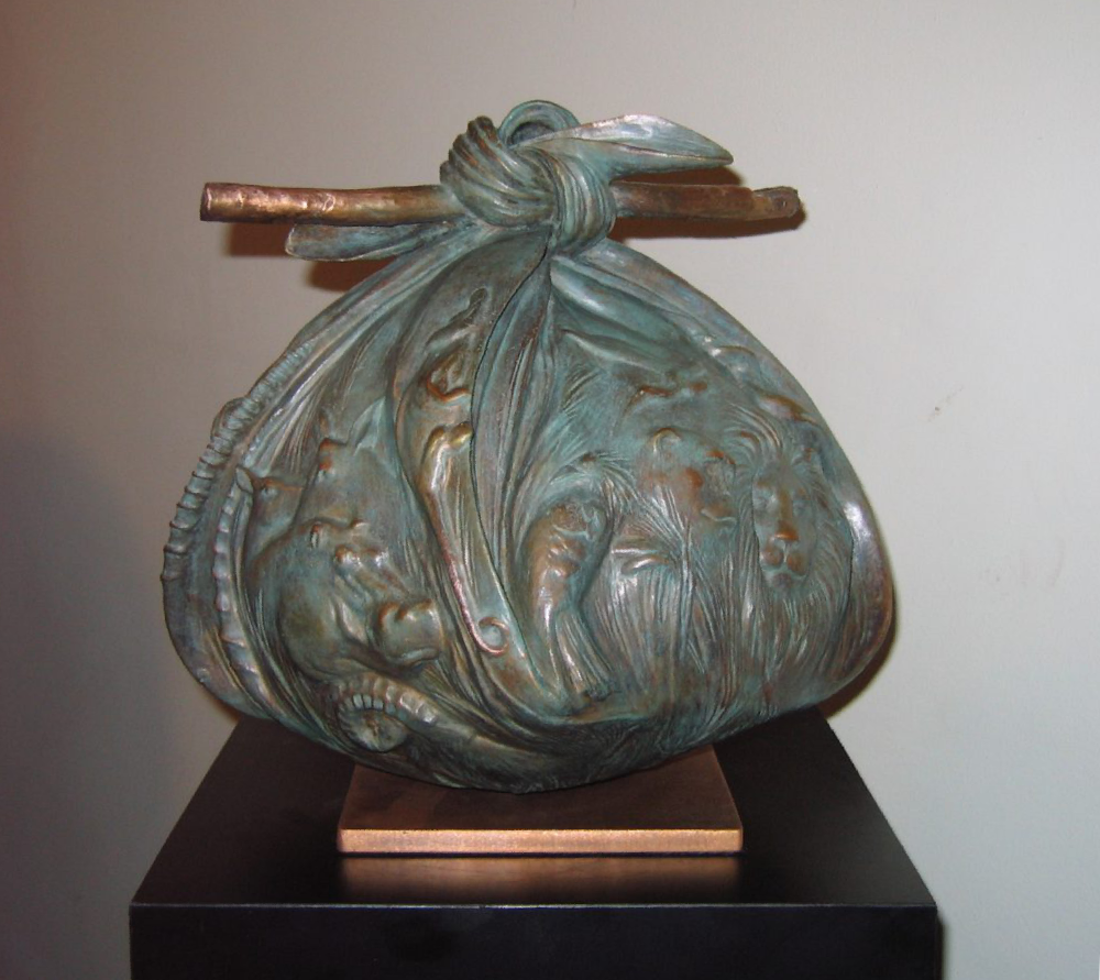 A Bronze casting of a bindle with African landscape