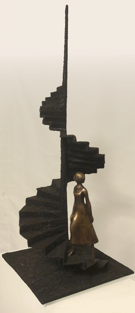 A bronze figure at the foot of a spiral staircase